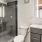 Bath with single vanity and large mirror with plenty of light.